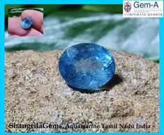 an oval blue gemstone sitting on top of a rock