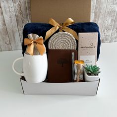 the gift box contains an assortment of personal care items, such as a mug, soap, and cookies