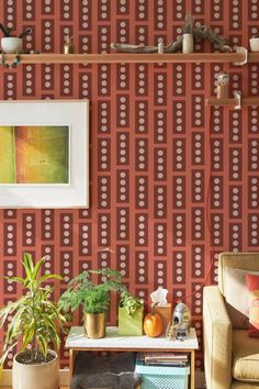 a living room filled with furniture and wallpaper next to a painting on the wall