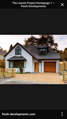 a white house with black roof and wooden fence in front of it, the words fresh development