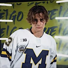 a young man wearing a jersey and sunglasses