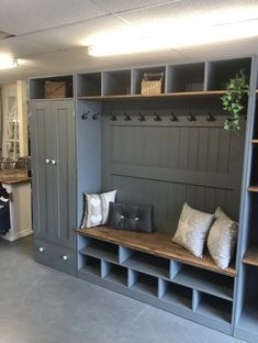 a room filled with lots of gray shelves and pillows on top of it's sides