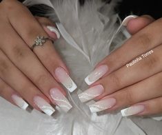 two hands with white and pink manicures on them, one holding a ring