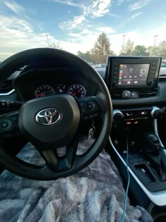 the interior of a vehicle with steering wheel, dashboard and touch screen monitor on display