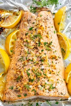 salmon on foil with lemons and herbs