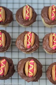 chocolate cupcakes with frosting and sprinkles on a cooling rack