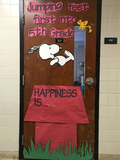 a door decorated with the words, jumping feet first into 5th grade and happiness is