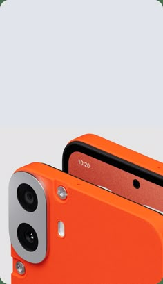 an orange cell phone with two cameras attached to it's back side and front facing the camera