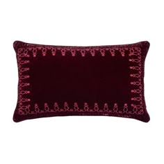 an embroidered pillow with red threadwork on it