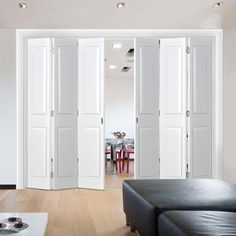 a living room filled with furniture and white doors