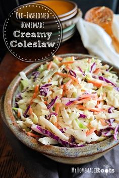 a bowl filled with coleslaw and carrots on top of a table