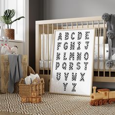 a baby's room with a crib, toy train and wall hangings