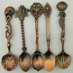 an assortment of antique spoons are lined up