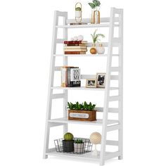 a white ladder shelf filled with books and plants