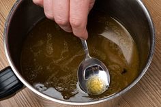 a person is stirring something in a pot with a spoon