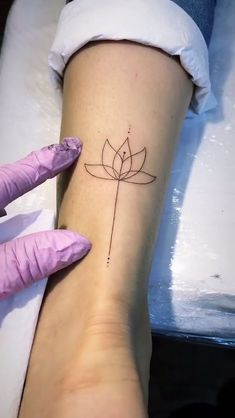 a woman's foot with a small tattoo on the side of her left leg