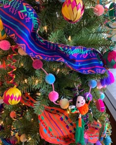 a colorful christmas tree decorated with ornaments