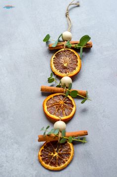 orange slices are arranged in a line with cinnamon sticks