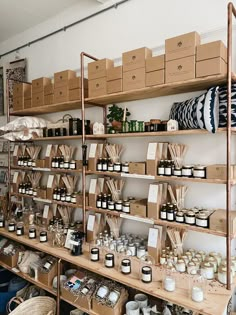 the shelves are filled with candles and other items for sale at the store's open air market