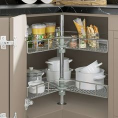 an open cabinet in a kitchen filled with dishes