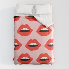 a bed with red and black lips on it