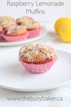 two lemon muffins sitting on top of a white plate