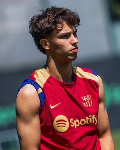 a young man wearing a red and yellow shirt