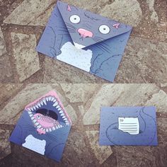 three pieces of paper cut out to look like cats with mouths and teeth on them