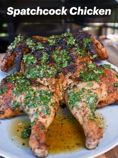 a plate topped with chicken covered in pesto