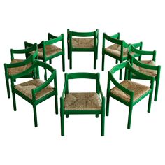 a set of eight green chairs with woven seats