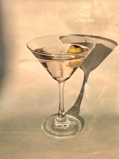 a martini glass with an olive in it