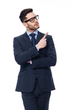 a man in a suit and tie is pointing at something with his indexl finger