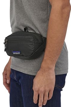 Great for any adventure, this Patagonia Ultralight Mini Hip Pack in Black has got us wanting to go on more adventures. There is a main zipper compartment to carry all your essentials needs and turns inside out for easy storage. Going on a hike has never been easier!Features of Patagonia Ultralight Mini Hip Pack in Black | 49447-BLK:PatagoniaStyle: 49447-BLKColor: Black100% Recycled NylonPatagonia hip packTurns inside for easy storageAdjustable clipTop zipperSide zipperPadded back for hip comfortPatagonia logo patch on front Patagonia Style, Patagonia Logo, Hip Pack, Black Holes, Webbing Belt, Hip Bag, Water Resistant Fabric, Black Hole, Sport Bag