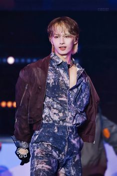 a male model in a blue and purple outfit