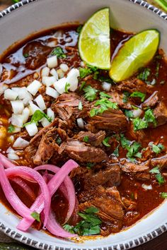 a white bowl filled with meat, onions and cilantro