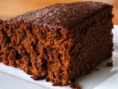 a piece of chocolate cake sitting on top of a white plate