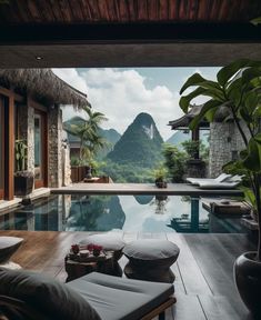 an outdoor swimming pool with mountains in the background