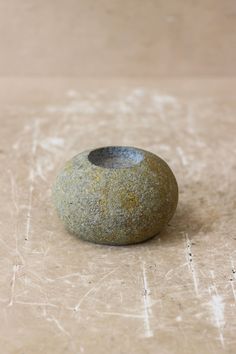 a rock sitting on top of a wooden table