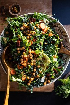 a salad with chickpeas, lettuce and carrots in a bowl