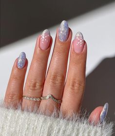 Get ready for the season with these stunning winter nails! From simple and elegant designs to festive winter nail art, these ideas are perfect for 2024/2025. Whether you're into minimalist looks or glittery French tips, these chic winter nails will keep your hands looking cute all season long. Get inspired with snowflake designs, metallic accents, and shimmery finishes that bring the cozy vibes of winter to your fingertips. Check out these easy and classy winter nail trends for holiday look! Frosty Pearl Nails, Blue Frosty Nails, Pearl Christmas Nails, Blue Pearl Nails, Blue Snowflake Nails, Easy Diy Manicure, Blue Winter Nails, Christmas Outfits Ideas, Christmas Nails Art