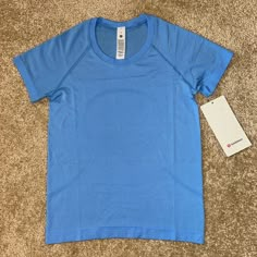 Nwt Lululemon Swiftly Race Length T-Shirt In Color “Aero Blue”, Size 4. Price Is Firm. Including Free Small Size Lululemon Tote (Pictured) With This Purchase. Great Gift For A Loved One (Or Yourself!) Sold Out Online! Beautiful Blue Color By Lululemon. Comment Any Questions, And Check Out My Closet For More Lululemon And Athletic Wear. Bundle To Save! If You’re New To Poshmark, Use Code Juliak326 When You Sign Up For $10 Off Your First Poshmark Purchase! Preppy Stuff For Christmas List, Lululemon Tshirts, Lululemon Tee Shirt, Lulu Lemon Tops, Lululemon T Shirt, Clothes Lululemon, Lululemon Swiftly, Lululemon Clothing, Lulu Tops