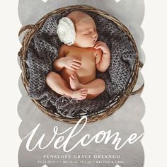 a baby is laying in a basket with the words welcome on it's side