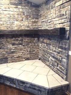 a bathroom with stone walls and tile flooring