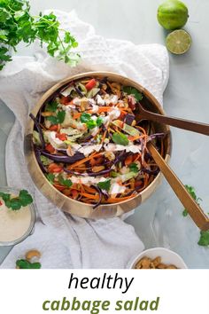 keto cabbage salad in a wooden bowl with serving utensils