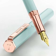 a fountain pen with the letter f on it's tip and an eraser