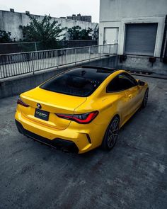 a yellow sports car parked in an empty parking lot