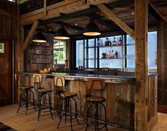 a bar with four stools in front of it