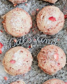 strawberry muffins with powdered sugar and the word be kind written on them