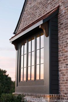 an image of a window on the side of a brick building that is lit up