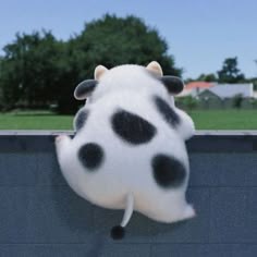 a dalmatian stuffed animal hanging from the side of a wall